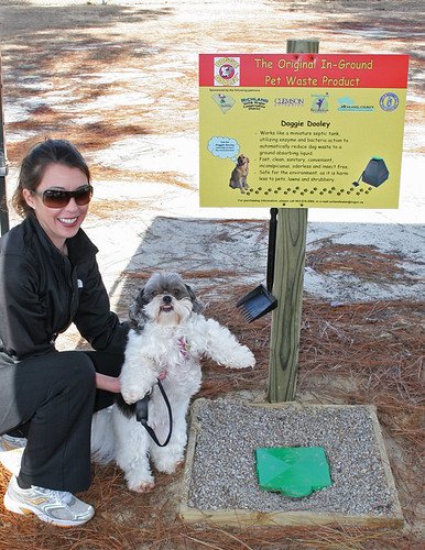 Elizabeth Brown and her dog Jane check out the pet waste disposal system at a park in Richland County, South Carolina.